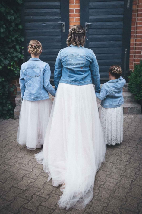 Hochzeitsidee, die Braut posiert mit ihren 2 Kindern in Jeansjacken